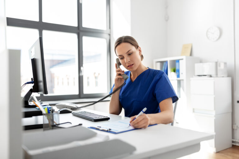 doctor with computer calling on phone at hospital