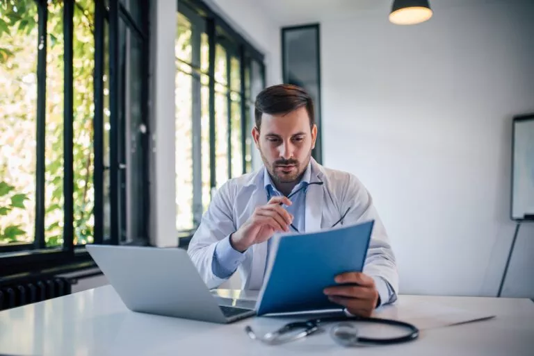 Portrait of a doctor doctor reviewing document in medical office.