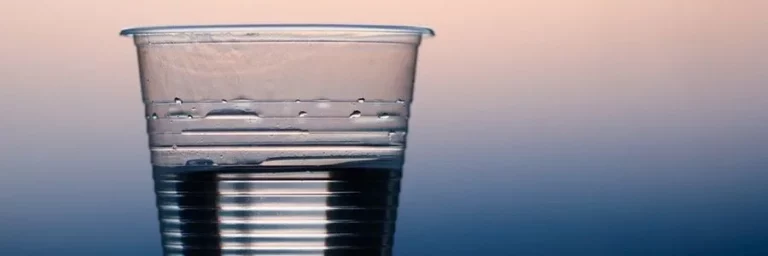 Wasserglas vor unscharfem Hintergrund – Dehydration und ihre Auswirkungen auf die Psyche